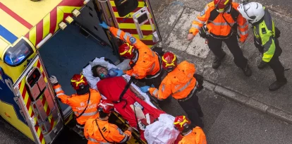 Trabajadores sanitarios evacuan a una mujer de un incendio que se desató en Wang Fuk Court, una urbanización en el distrito de Tai Po, en los Nuevos Territorios de Hong Kong, el jueves 27 de noviembre de 2025