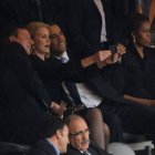 US President  Barack Obama (R) and British Prime Minister David Cameron pose for a picture with an unidentified official next to US First Lady Michelle Obama (R) during the memorial service of South African former president Nelson Mandela at the FNB Stadium (Soccer City) in Johannesburg on December 10, 2013. Mandela, the revered icon of the anti-apartheid struggle in South Africa and one of the towering political figures of the 20th century, died in Johannesburg on December 5 at age 95.   AFP PHOTO / ROBERTO SCHMIDT