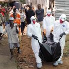 Health workers remove the body of Prince Nyentee, a man whom local residents said died of Ebola virus in Monrovia