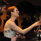 Winner for Best Actress Julianne Moore looks at her polished trophy at the Governor’s Ball following the 87th Oscars February 22, 2015 in Hollywood, California. AFP PHOTO / VALERIE MACON