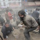 TOPSHOTSPeople clear rubble in Kathmandu’s Durbar Square, a UNESCO World Heritage Site that was severely damaged by an earthquake on April 25, 2015. A massive 7.8 magnitude earthquake killed hundreds of people April 25 as it ripped through large parts of Nepal, toppling office blocks and towers in Kathmandu and triggering a deadly avalanche that hit Everest base camp. AFP PHOTO / PRAKASH MATHEMA