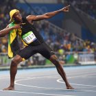 Jamaica's Usain Bolt does his 'Lightening Bolt' pose as he celebrates winning the Men's 100m Final during the athletics event at the Rio 2016 Olympic Games at the Olympic Stadium in Rio de Janeiro on August 14, 2016.   / AFP / OLIVIER MORIN