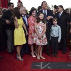 Spanish singer Julio Iglesias, center right, smiles during his star unveiling ceremony at the Walk of Fame in San Juan, Puerto Rico, Thursday, Sept. 29, 2016. Iglesias who has Puerto Rican ancestry by his maternal grandmother will offer a concert at the Fine Arts Center in San Juan. (AP Photo/Carlos Giusti)