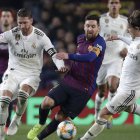 Barcelona forward Lionel Messi, center, Real defender Sergio Ramos, left, and Real midfielder Luka Modric, right, vie for the ball during the Copa del Rey semifinal first leg soccer match between FC Barcelona and Real Madrid at the Camp Nou stadium in Barcelona, Spain, Wednesday Feb. 6, 2019. (AP Photo/Emilio Morenatti)