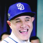 Manny Machado talks with family members after a news conference at San Diego Padres spring training baseball camp Friday, Feb. 22, 2019, in Peoria, Ariz. Machado signed a 10-year, $300 million deal to join the Padres. (AP Photo/Charlie Riedel)