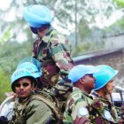 United Nations peacekeepers drive past local residents as they custody an United Nations convoy, heading to Rutshuru to relaunch UN operations in the area, north of the provincial capital of Goma, Congo, November 3, 2008. UN peacekeepers will "do the maximum" to protect civilians in rebel-threatened Goma, UN peacekeeping chief  French Alain Le Roy warned during a visit to the eastern Democratic Republic of Congo city Monday.         AFP PHOTO/Yasuyoshi CHIBA