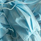 Used blue surgical protective masks. Coronavirus (COVID-19) hysteria is leading to mass mask shortages in the beginning of 2020.