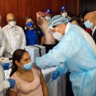 El ministerio de Salud al momento de vacunar a una de las docentes en Santiago. (Fuente externa).