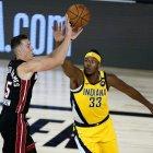 Miami Heat's Duncan Robinson shoots as Indiana Pacers' Myles Turner (33) defends during the first half of an NBA basketball first round playoff game, Monday, Aug. 3, 2020, in Lake Buena Vista, Fla. (AP Photo/Ashley Landis, Pool)