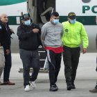 Cristian Camilo Monsalve, who according to the authorities is implicated in the murder of Paraguayan prosecutor Marcelo Pecci, is escorted by Colombian police upon his arrival at the Military Transport Air Command (CATAM) in Bogota, Colombia June 8, 2022. REUTERS/Luisa Gonzalez
