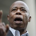 New York City Mayor Eric Adams speaks while surrounded by faith leaders and other supporters during a rally and prayer vigil on the steps of City Hall in New York, Tuesday, Oct. 1, 2024. (AP Photo/Seth Wenig)