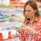 woman-looking-at-a-nutrition-label-1080×608