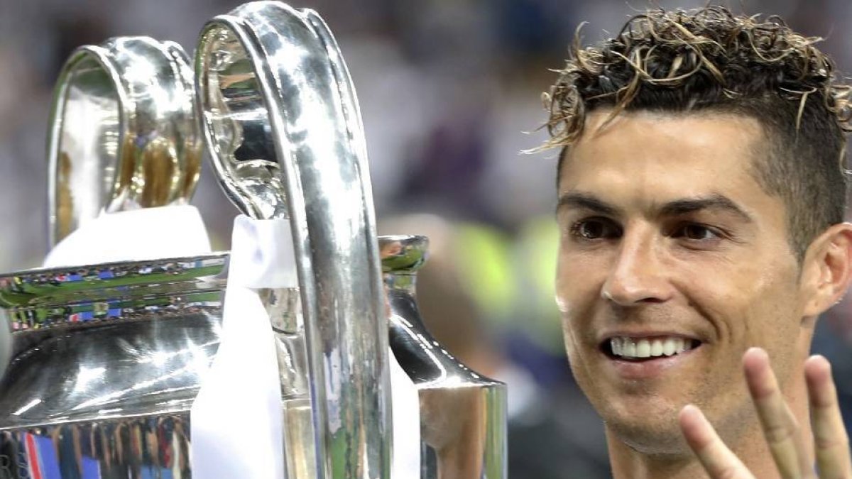 FILE - In this Saturday, May 26, 2018 file photo Real Madrid's Cristiano Ronaldo celebrates with the trophy after winning the Champions League Final soccer match between Real Madrid and Liverpool at the Olimpiyskiy Stadium in Kiev, Ukraine. (AP Photo/Pavel Golovkin)