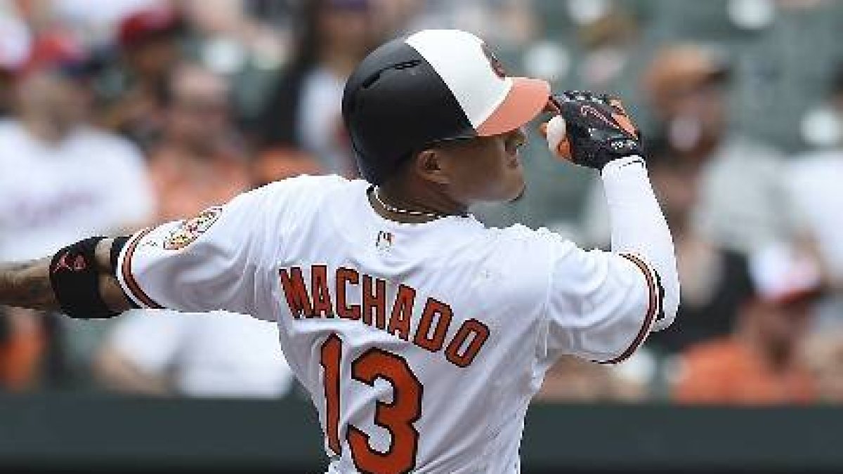Baltimore Orioles' Manny Machado follows through on a solo home run against the Texas Rangers in the first inning of a baseball game, Sunday, July 15, 2018, in Baltimore. (AP Photo/Gail Burton)