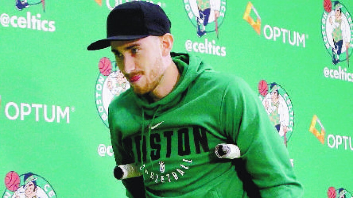 Boston Celtics' Gordon Hayward uses crutches as he steps away from a podium after taking questions from members of the media at an NBA basketball news conference, Thursday, Nov. 2, 2017, at the team's' training facility in Waltham, Mass. Hayward, who broke his ankle about 5 minutes into his NBA career opener at Cleveland on Oct. 17, says he knows he will not play again this season, after needing surgery to repair the injury. (AP Photo/Steven Senne)