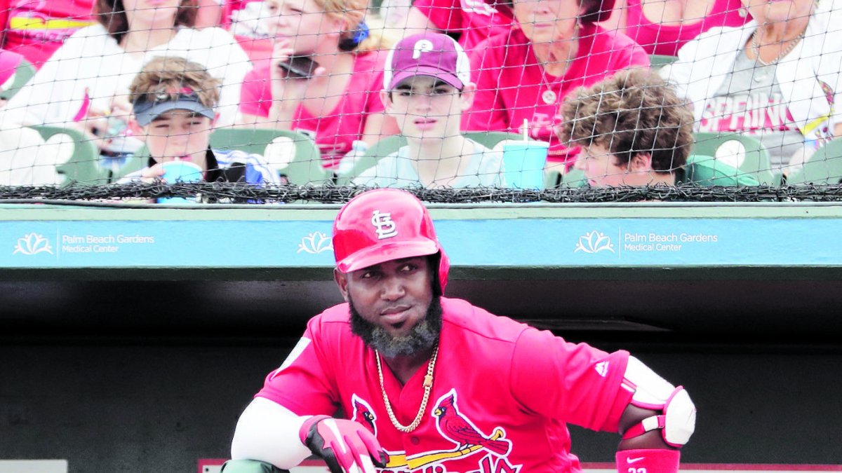 St. Louis Cardinals' Harrison Bader, left, and St. Louis Cardinals' Marcell Ozuna, right, look out at the field from the dugout during an exhibition spring training baseball game Monday, March 18, 2019, in Jupiter, Fla. (AP Photo/Brynn Anderson)
