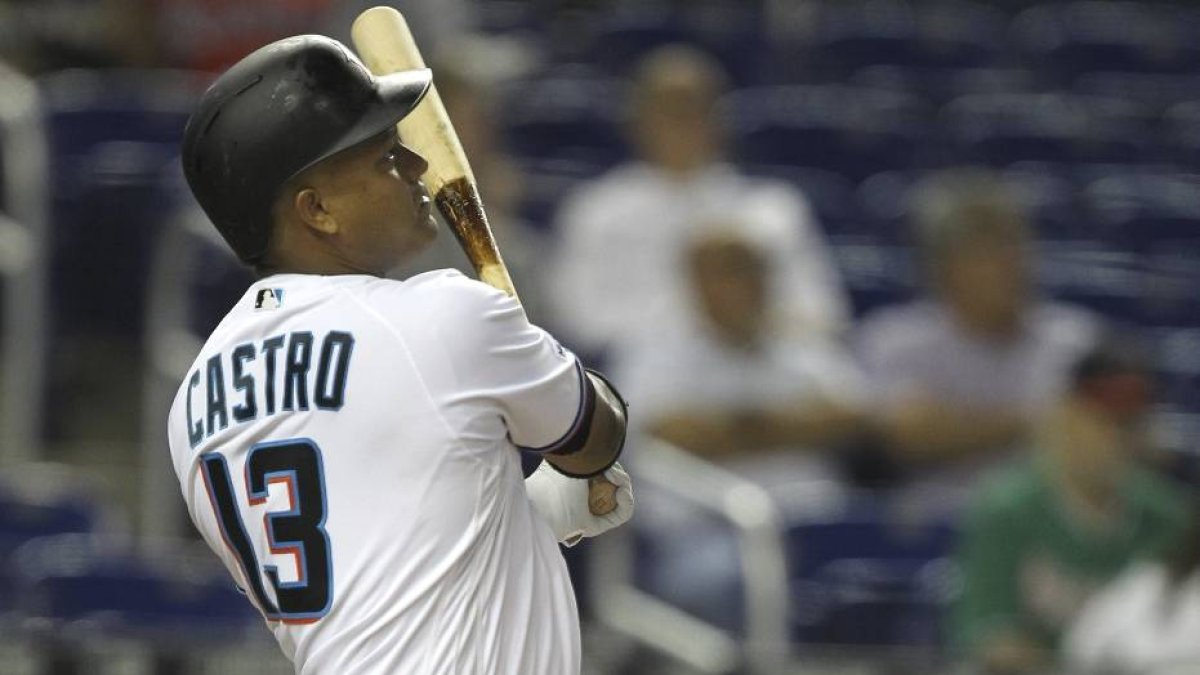 Miami Marlins' Starlin Castro watches his two-run home run during the first inning of the team's baseball game against the Atlanta Braves, Thursday, Aug. 8, 2019, in Miami. (AP Photo/Luis M. Alvarez)