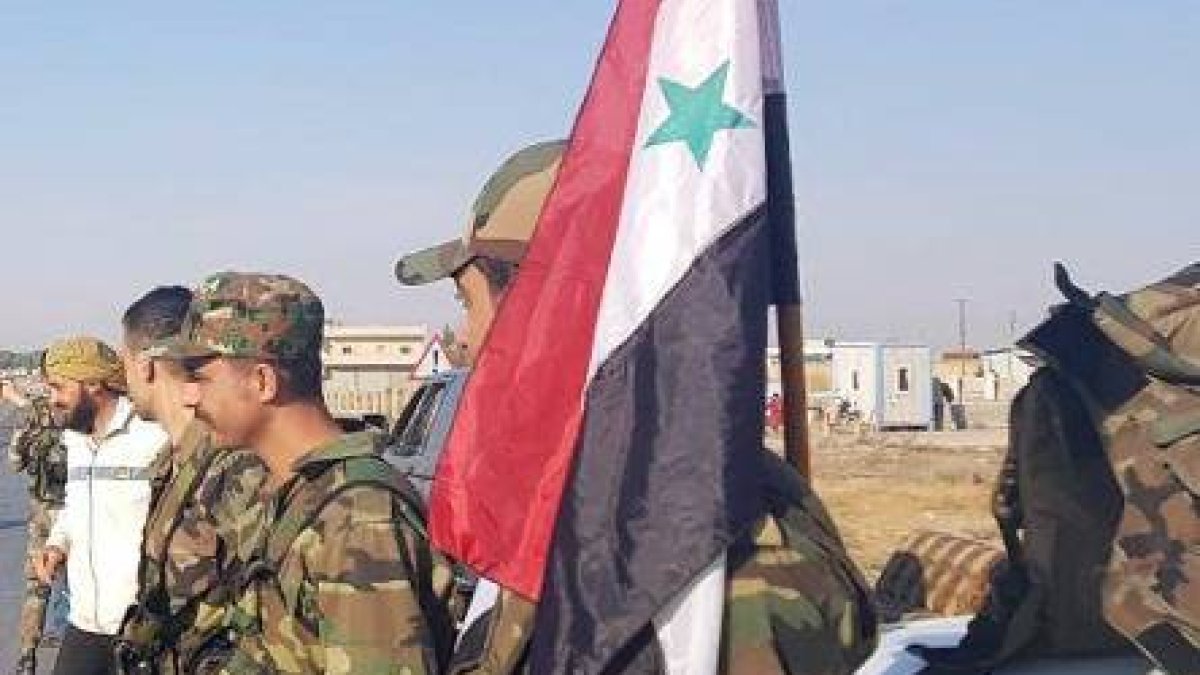 In this photo released by the Syrian official news agency SANA, residents welcome Syrian soldiers shortly after they entered the northern town of Tal Tamr on Monday, Oct 14, 2019. The move toward Tal Tamr came a day after Syria's Kurds said Syrian government forces agreed to help them fend off Turkey's invasion — a major shift in alliances that came after President Donald Trump ordered all U.S. troops withdrawn from the northern border area amid the rapidly deepening chaos. (SANA via AP)