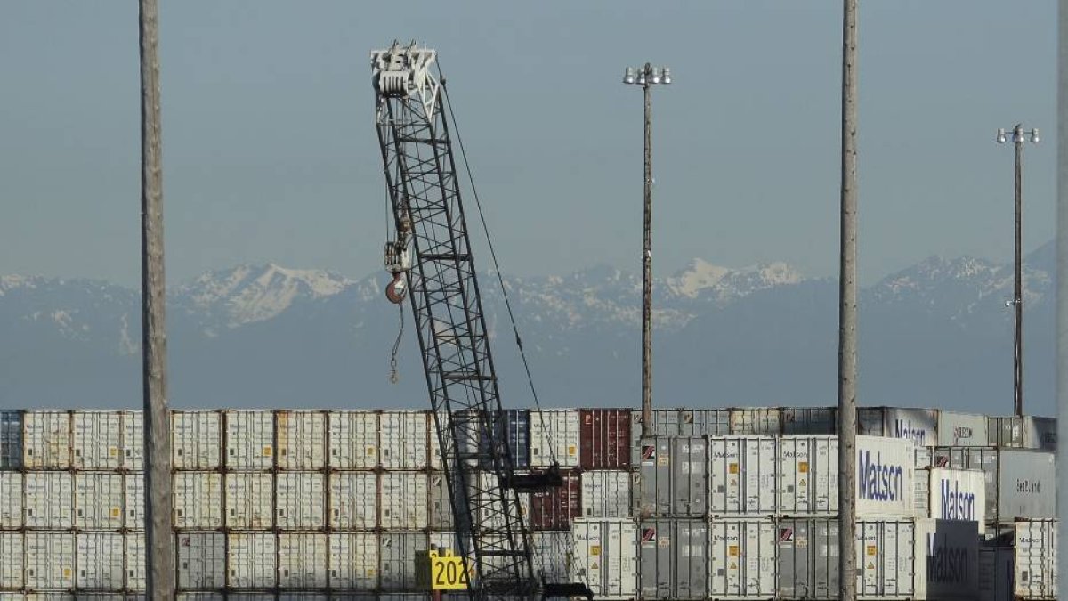 FILE - In this May 10, 2019 file photo, a worker walks near truck trailers and cargo containers at the Port of Tacoma in Tacoma, Wash. Hundreds of businesses, trade groups and individuals have written to complain about President Donald Trump's threat to impose tariffs on the remaining $300 billion in Chinese goods that he hasn't already hit with 25% import taxes, saying the additional import taxes would drive up prices for consumers, squeeze profits and leave U.S. companies at a competitive disadvantage to foreign rivals that aren't subject to higher taxes on the vital components they buy from China.  (AP Photo/Ted S. Warren, File)