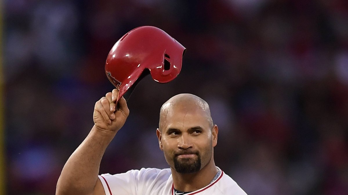 Los Angeles Angels' Albert Pujols tips his helmet to fans after hitting an RBI double during the third inning of a baseball game against the Seattle Mariners Saturday, April 20, 2019, in Anaheim, Calif. With that RBI, Pujols tied Babe Ruth for 5th place on the all-time RBI list with 1,992. (AP Photo/Mark J. Terrill)