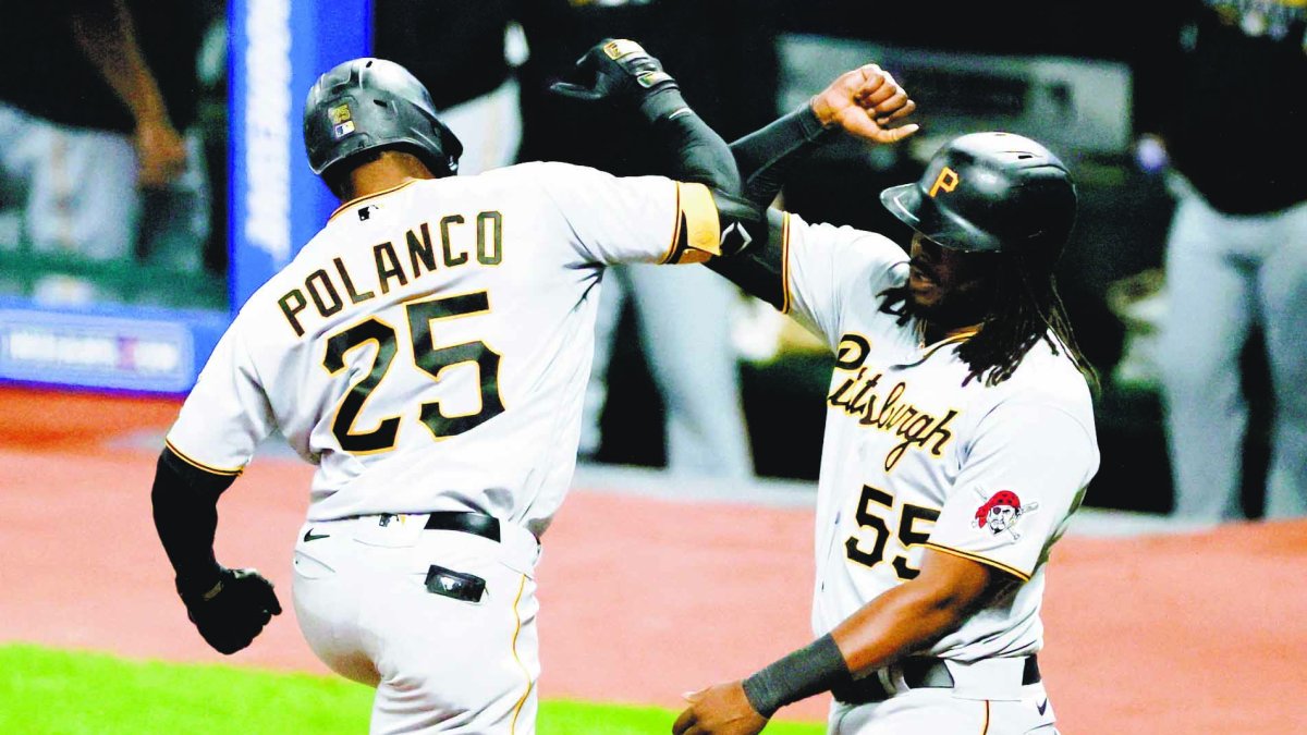 Pittsburgh Pirates' Gregory Polanco (25) celebrates with Josh Bell (55) after hitting a two-run home run off Cleveland Indians starting pitcher Carlos Carrasco during the fourth inning of a baseball game Friday, Sept. 25, 2020, in Cleveland. (AP Photo/Ron Schwane)