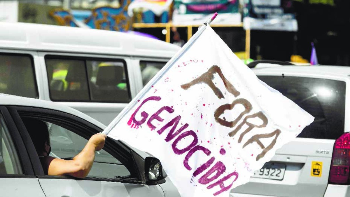 BRA50. RÍO DE JANEIRO (BRASIL), 23/01/2021.- Grupos de personas en sus coches participan una caravana en apoyo a la petición de realizar un juicio político al presidente de Brasil, Jair Bolsonaro, por su cuestionada gestión frente a la pandemia del coronavirus hoy, en el centro de Río de Janeiro (Brasil). La tasa de desaprobación del Gobierno de Jair Bolsonaro aumentó ocho puntos porcentuales desde diciembre y llegó al 40 %, en medio del agravamiento de la pandemia del coronavirus y el fin de los subsidios por parte del Gobierno, según un sondeo divulgado ayer viernes. De acuerdo con la encuesta, realizada por el instituto Datafolha, por el contrario el índice de aprobación pasó del 37 % en diciembre al 31 % actual, lo que demuestra una caída de la popularidad del jefe de Estado, uno de los líderes más negacionistas sobre la gravedad de la pandemia. EFE/ Fabio Motta