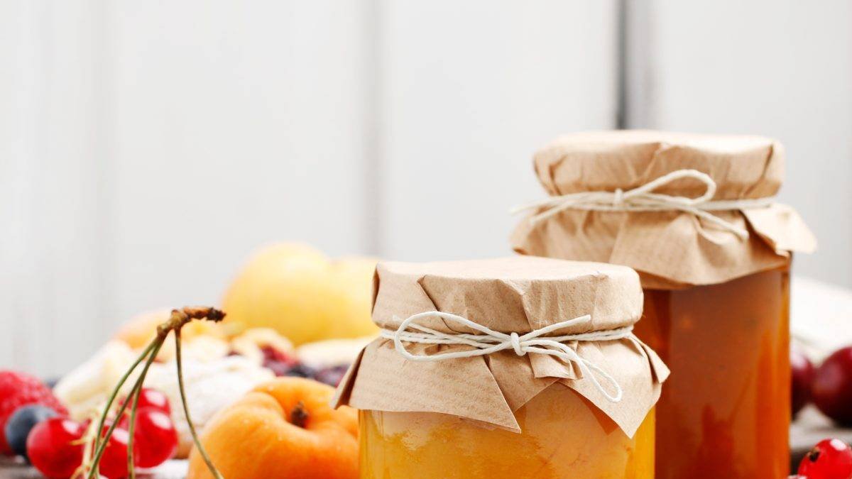 Two,Jars,With,Peach,Jam,And,Fresh,Fruits,On,Stone