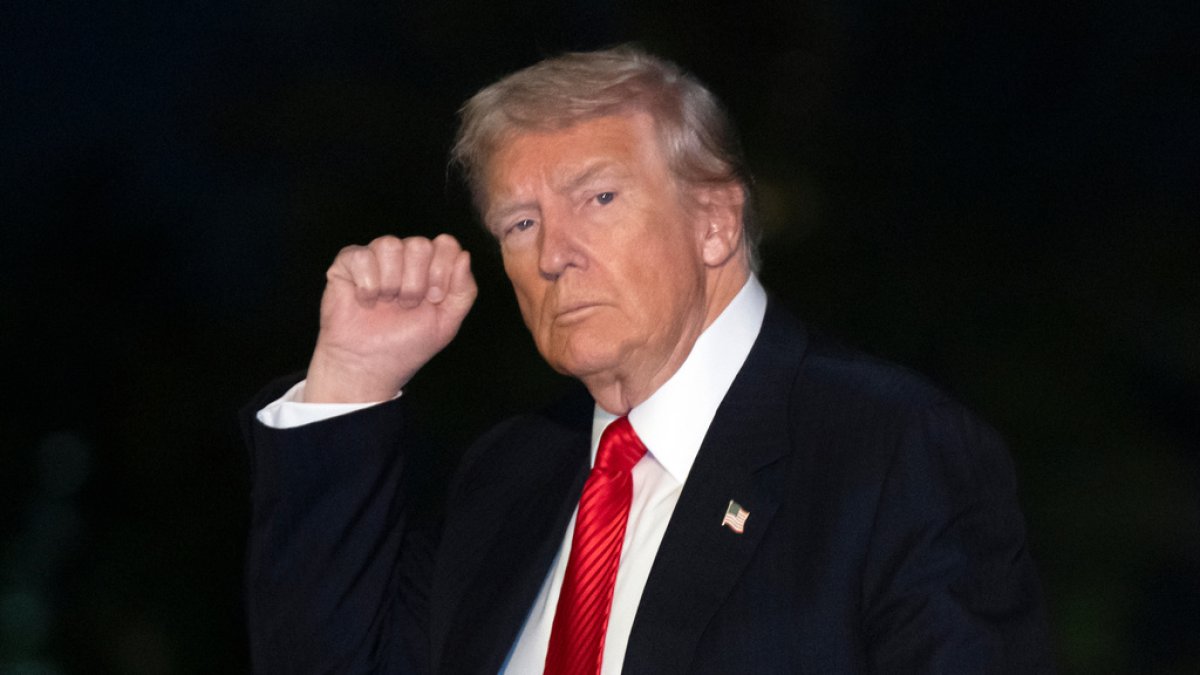 President Donald Trump gestures while walking across the South Lawn of the White House, Sunday, Nov. 2, 2025, in Washington, after returning from a trip to Florida. (AP Photo/Mark Schiefelbein)