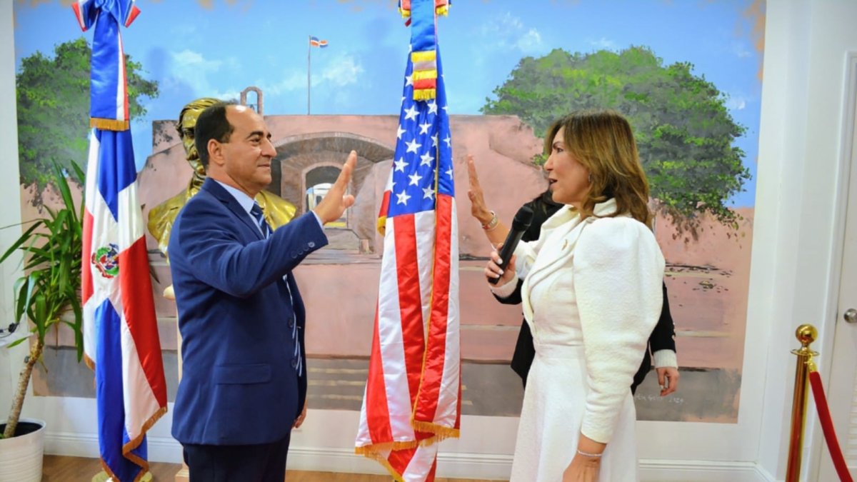 En la gráfica, parte de los funcionarios oficiales consulares, el director del INDEX, Juramentación simbólica del nuevo Encargado Interino del Consulado General, vicecónsul licenciado Gilberto Minaya de manos de la cónsul saliente, la doctora Geanilda Vásquez. (Foto cortesía del Fotoreportero Ramón Morillo)