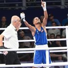 Yunior Alcántara 
celebra tras ganar combate en uno de los eventos del ciclo olímpico, en cada uno de los cuales subió al podio, completando una actuación de ensueño.