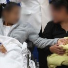 La bebé Aylin es cargada por su abuela Janet Vergara (d) este miércoles, el Hospital Cayetano Heredia de Lima (Perú)