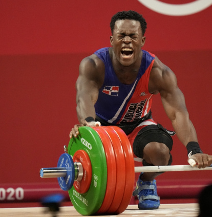 Zacarias Bonnat Michel of Dominican Republic reacts to an unsuccessful attempt as he competes in the men's 81kg weightlifting event, at the 2020 Summer Olympics, Saturday, July 31, 2021, in Tokyo, Japan. (AP Photo/Luca Bruno),Zacarias Bonnat Michel of Dominican Republic reacts to an unsuccessful attempt as he competes in the men's 81kg weightlifting event, at the 2020 Summer Olympics, Saturday, July 31, 2021, in Tokyo, Japan. (AP Photo/Luca Bruno)