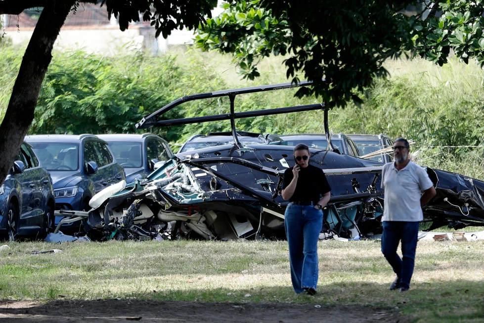 Los restos del helicóptero se encuentran en el estacionamiento de un concesionario de automóviles donde, según la policía, dos helicópteros chocaron en el aire y se estrellaron, el domingo 14 de junio de 2026, en Río de Janeiro, Brasil. (Foto AP/Bruna Prado)