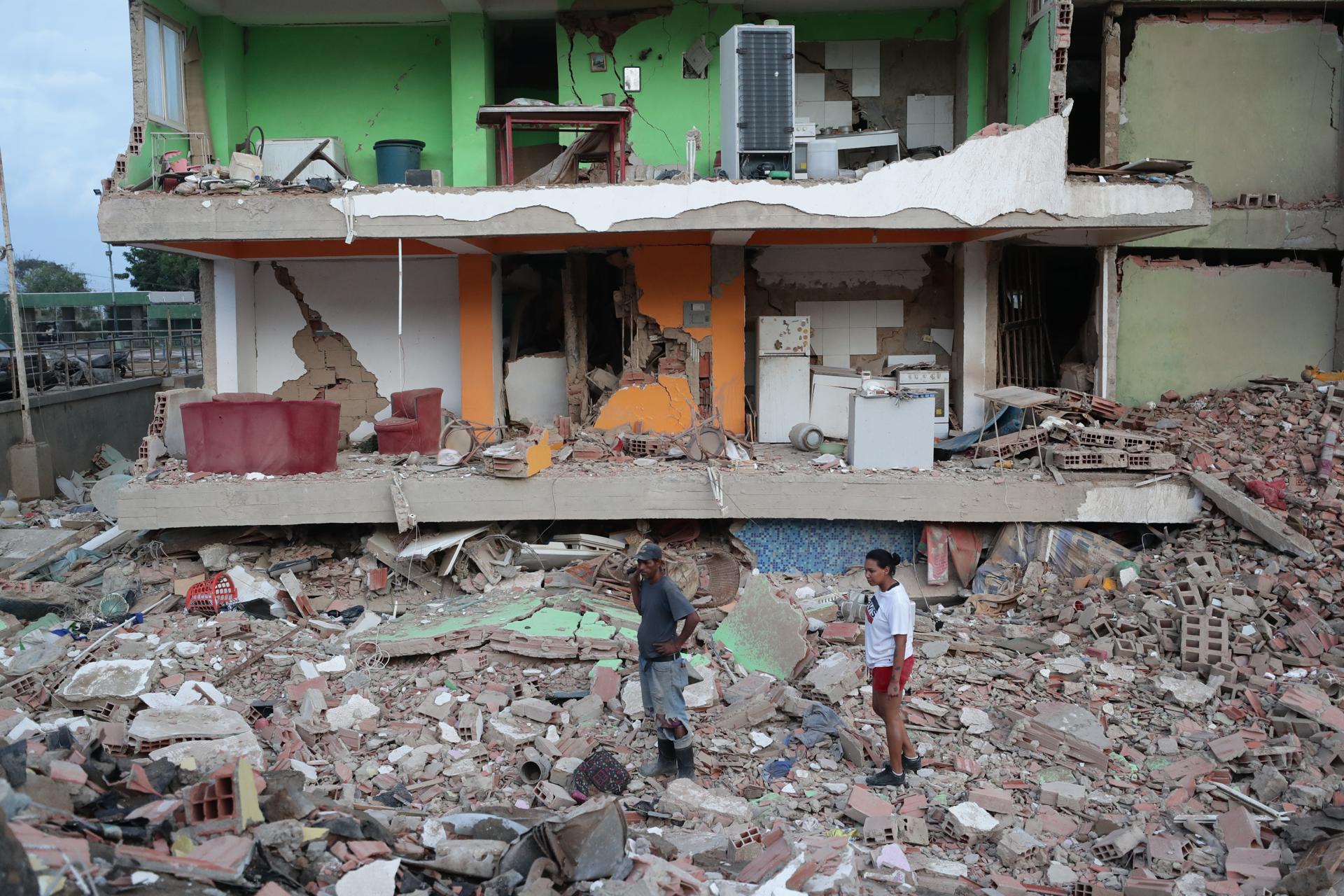 Dos vecinos se derrumbaron entre los escombros de un bloque de viviendas tras un terremoto en la ciudad de Catia la Mar, en el estado costero de La Guaira (Venezuela), este jueves. EFE/Ronald Peña r.