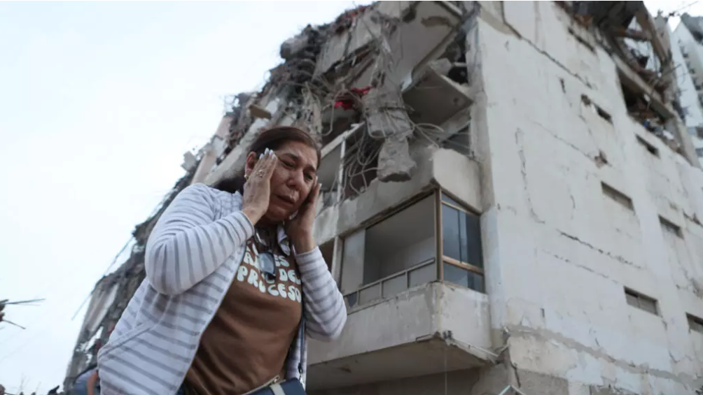 Una mujer pasa junto a un edificio dañado por el terremoto en La Guaira, Venezuela, este jueves 25 de junio de 2026. AP Photo/Pedro Mattey - Pedro Mattey