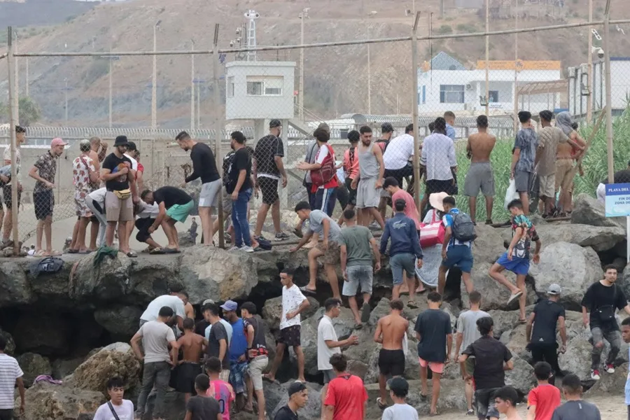 Grupos de inmigrantes empiezan a volver a su país por la frontera del Tarajal en Ceuta este viernes, donde se han registrado violentos enfrentamientos en los perímetros fronterizos durante su intento de acceder desde Marruecos hacia Ceuta y Melilla. EFE/ Reduan Dris